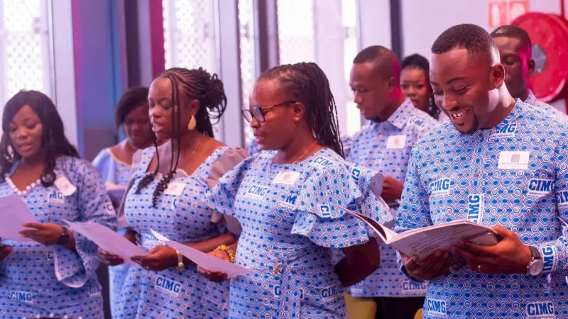 CIMG members reading together during an induction ceremony